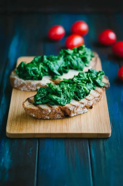 Steamed spinach on two slices of toasted bread