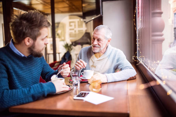 istock Senior father and his young son in a cafe. 888855824
