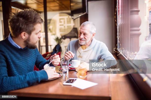 Senior Father And His Young Son In A Cafe Stock Photo - Download Image Now - Senior Adult, Cafe, Father