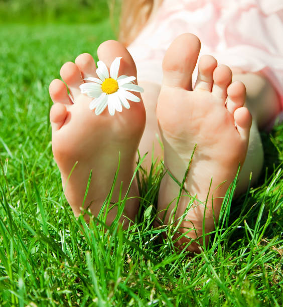 istock feet of a child with flower 888856534