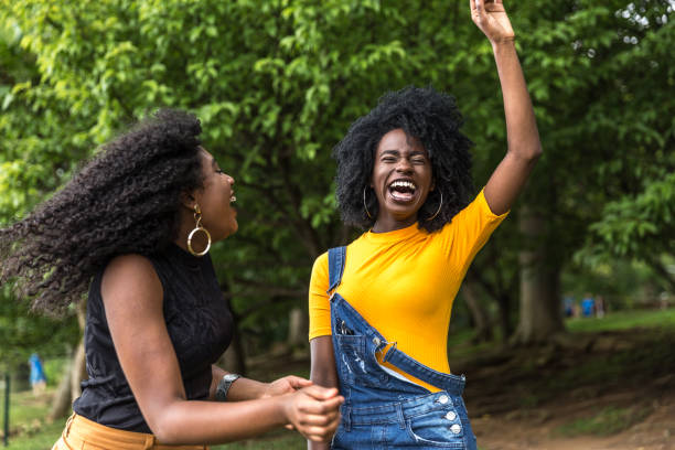 istock Afro descent girls dancing in the park 888856968