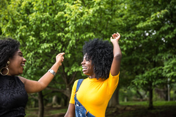 istock Afro descent girls dancing in the park 888857038