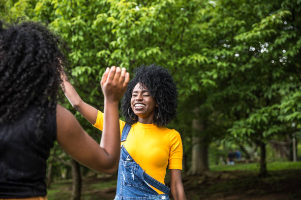 istock Afro descent girls dancing in the park 888857046