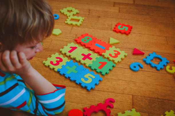 istock little boy playing with puzzle, education concept 888857638