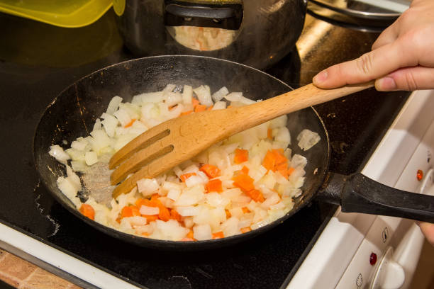 istock Stewed carrot and onion in frying pan 888859782