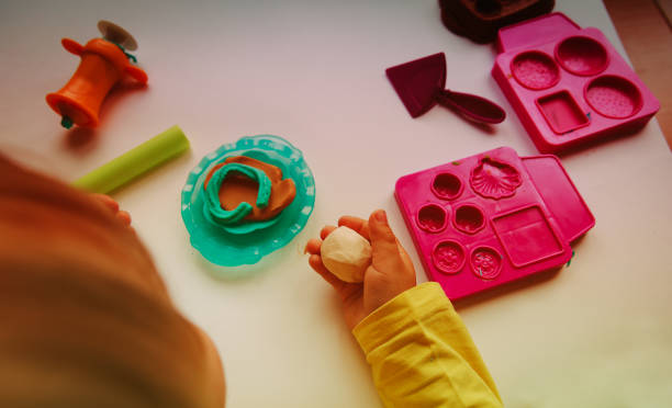 istock Child playing with clay molding shapes 888860350