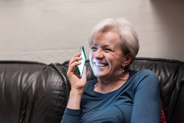 istock Senior woman with smartphone at home sitting 888865742