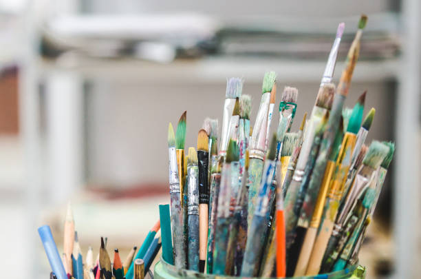 istock Set of watercolor brushesin a artist studio. Soft focus 888878502