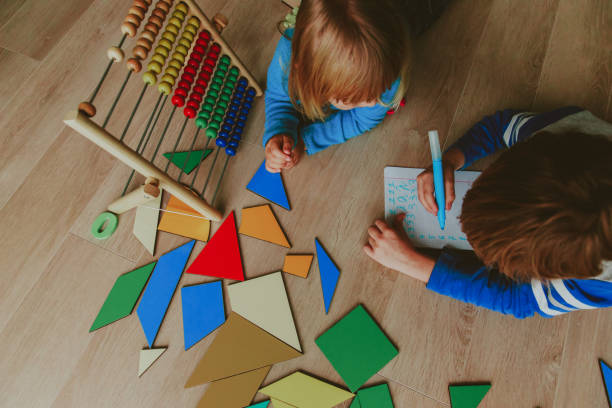 istock little boy and girl learn to write and calculate numbers 888883124