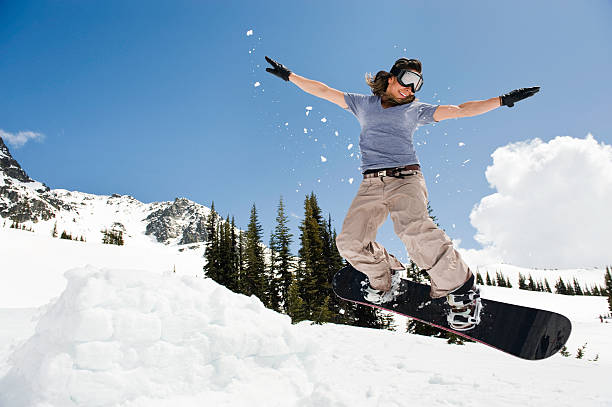 female snowboarder jumping through air  snowboarding snowboard women snow stock pictures, royalty-free photos & images