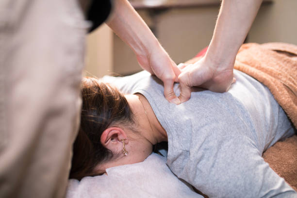 woman receiving massage in salon stock photo
