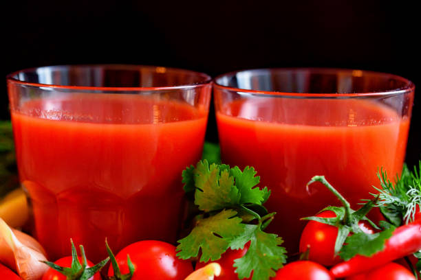 istock Glass of tomato juice with fresh tomatoes 888889610
