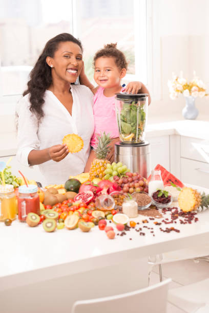 istock Mother with daughter 2-3 years age making fruit juices at kitchen. 888892006