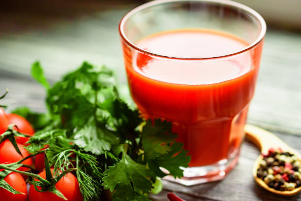 istock Glass of tomato juice with fresh tomatoes 888892418