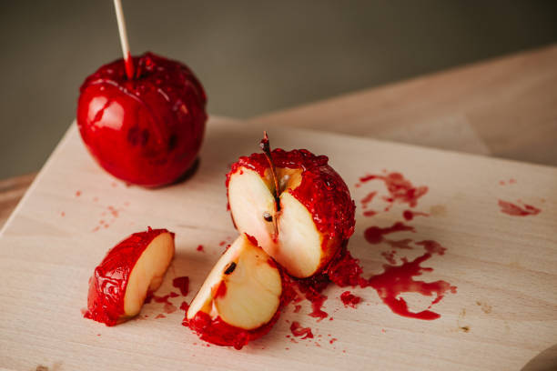 istock Sweet caramel dipped apple slices on wooden table. 888893310