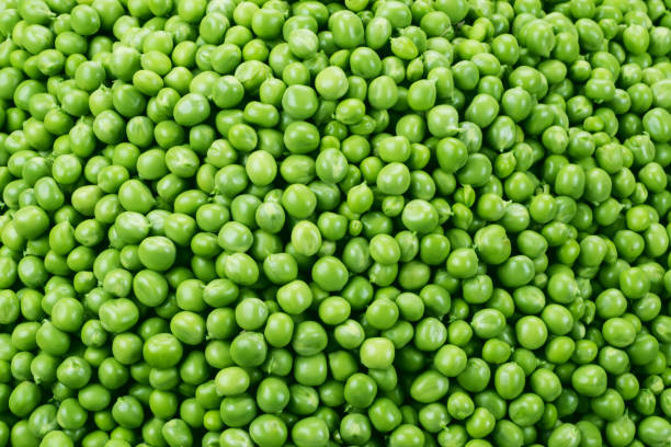 istock Peas background. Green peas. Green background. Texture. Top view. 888907670