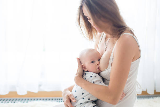 istock Young mother breastfeeding her newborn baby boy 888917308