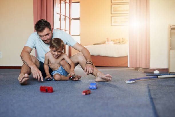 istock One day he'll teach him to drive a real car 888921436