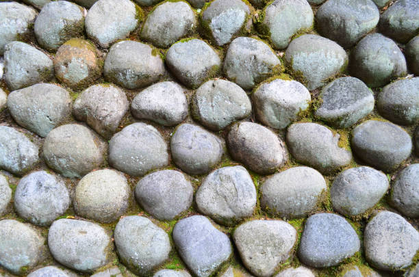 istock Round granite stone wall with green moss 888929002