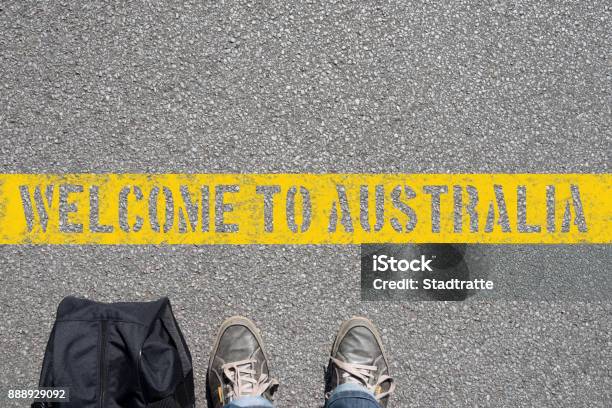 A Man With A Suitcase Stands On The Border With Australia Stock Photo - Download Image Now