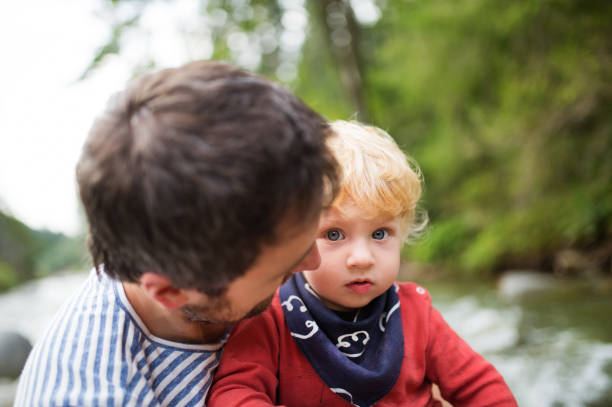 istock Young father with little boy at the river, summer day. 888929460