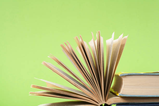 istock Open book on wooden table on green background. Back to school.Copy space for text. 888934134