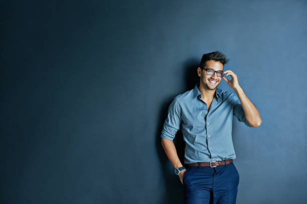 He will see you later Studio shot of cheerful young man with glasses standing with one hand in his pocket while looking at the camera handsome people stock pictures, royalty-free photos & images