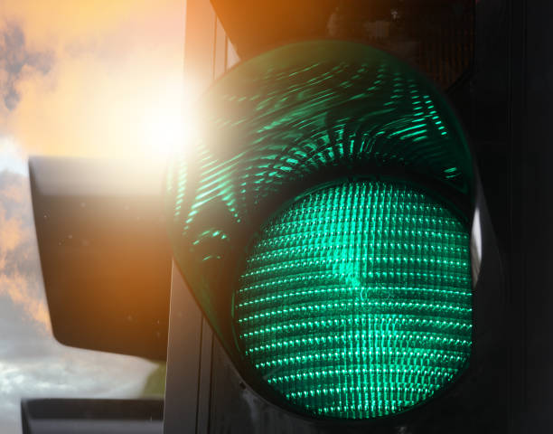 Sunlit green traffic light Sunlit green traffic light. Sunlit from low sun. green light stoplight stock pictures, royalty-free photos & images