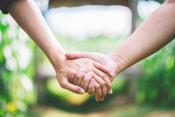 Hand-in-hand. Couple love in forest.