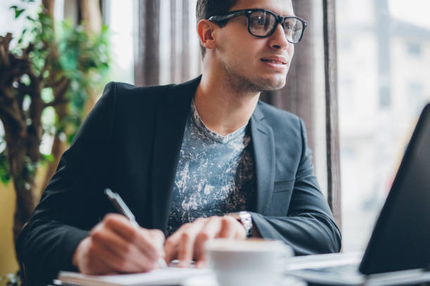 istock Businessman with laptop and coffee on table 888954800