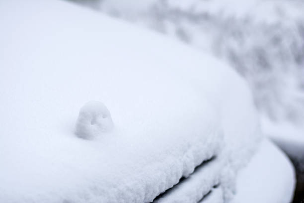 istock Snowfall in the city, snow covered car 888956988