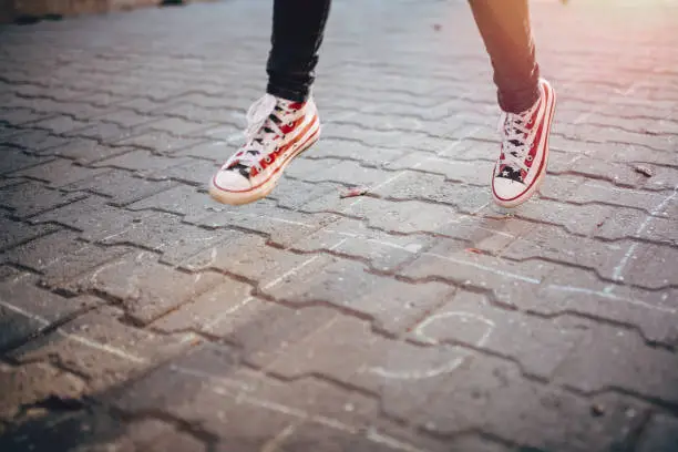 Photo of girl playing Hopscotch