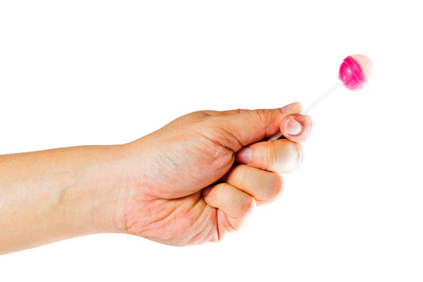istock Hand holding candy stick.The gesture is submitting candy.Clipping path inside. 888960082