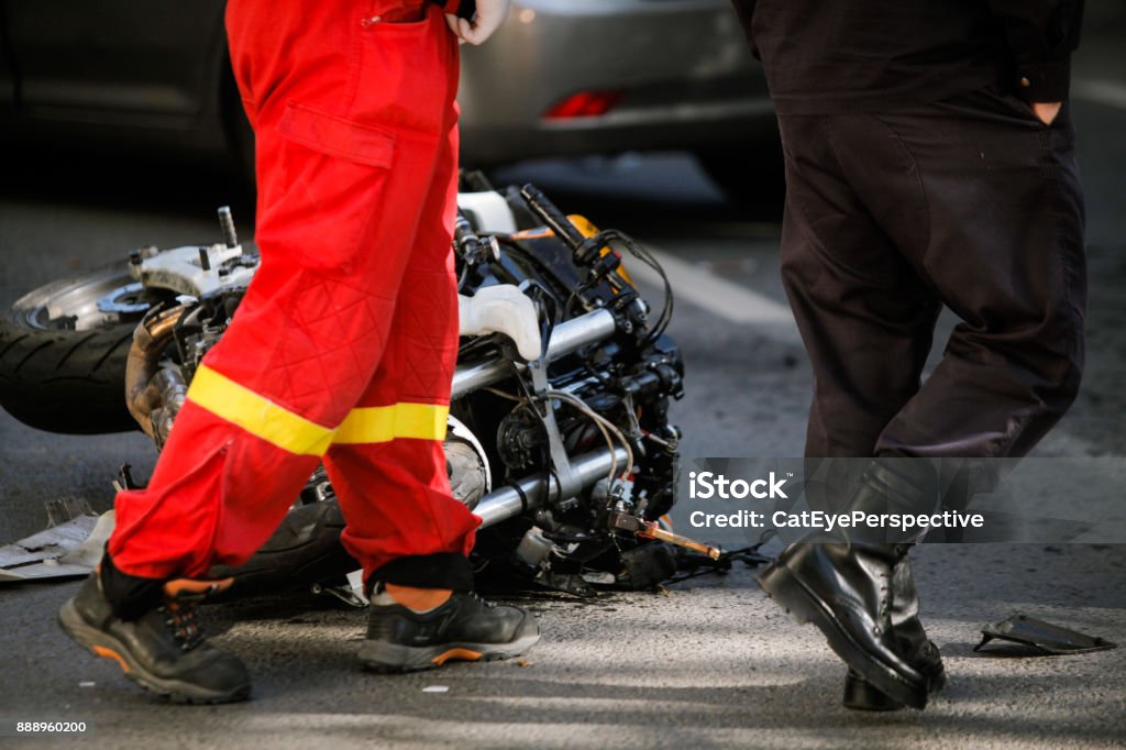 Crashed motorcycle after road accident with a ca Crashed motorcycle after road accident with a car on a city street Motorcycle Stock Photo