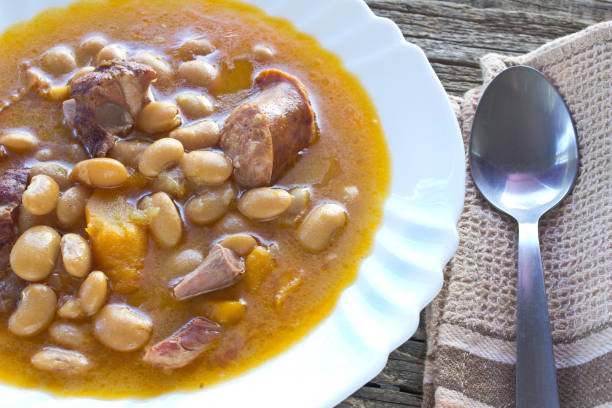 istock Bean soup in plate on wooden table 888960720