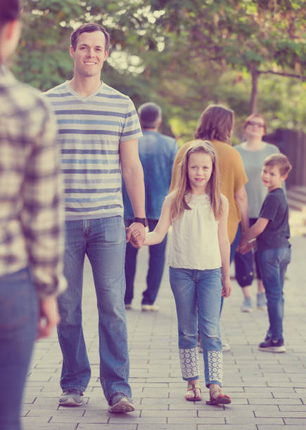 istock People of different ages walk in park 888960770