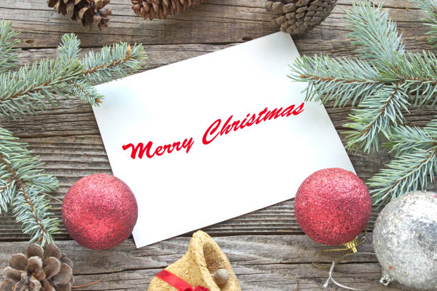 istock Merry Christmas with pine tree needles,baubles and cones on wooden background 888967924