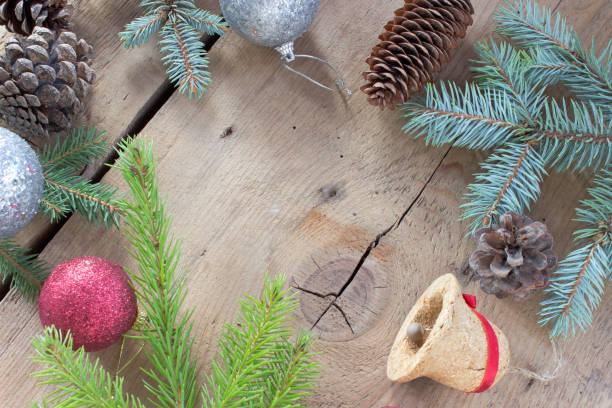 istock Merry Christmas with pine tree needles,baubles and cones on wooden background 888968178