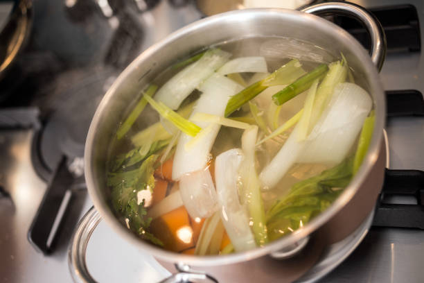 Professional chef preparing meal in private house: Vegetable soup broth