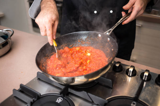 istock Professional chef preparing meal in private house: Adding bread to Pappa al pomodoro (tomato soup) 888976722