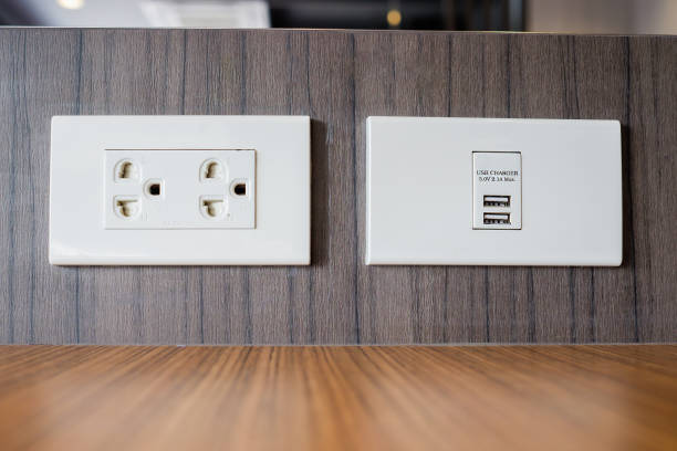 Electrical outlet with built in USB charger for service customers at table in restaurant in Thailand