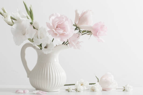 istock pink and white flowers in vase on white background 888977822
