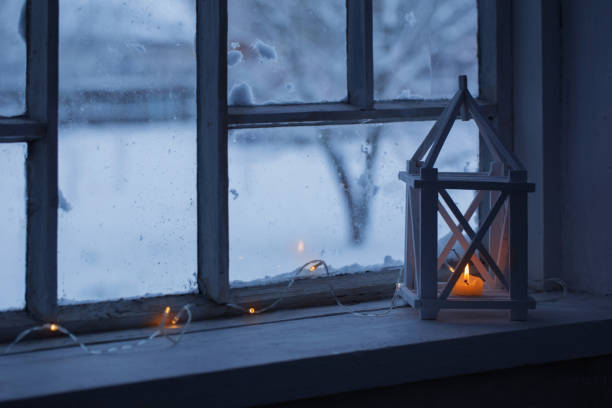 istock wooden lantern on windowsill on background winter landscape 888982802