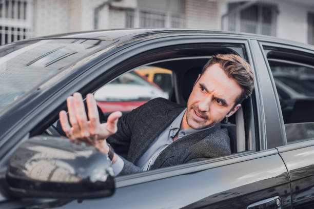 Businessman getting angry in the car An attractive businessman is seen getting angry in the car. impatient stock pictures, royalty-free photos & images