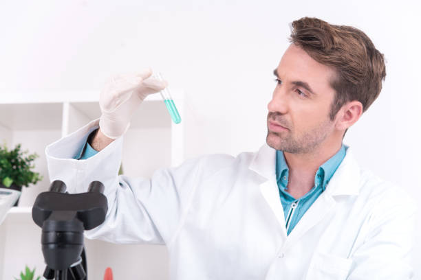 istock Scientist examining the liquid that is inside of the test tube 888988532
