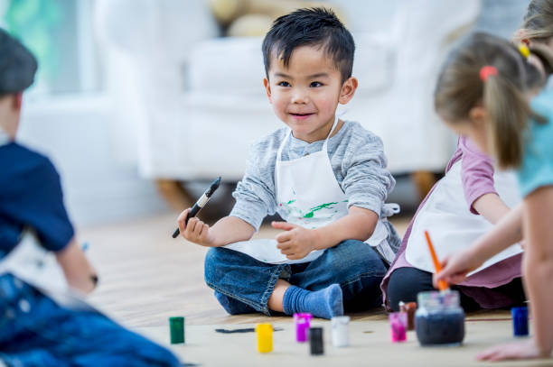 istock Happy Boy Painting A Picture 888991904