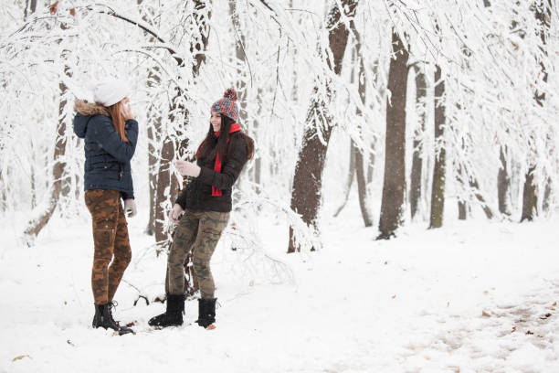 istock Young women enjoying in snow 889000666