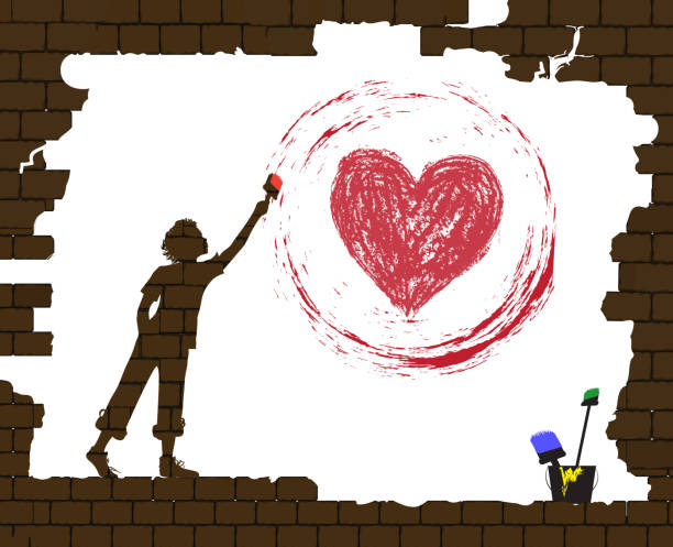 istock boy draws a red heart by paint on the old broken brick wall, life after war, new life after disaster idea, protect homeless children idea graffiti, 889008048