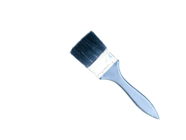 Photo of A blue paint brush isolated on a white background.