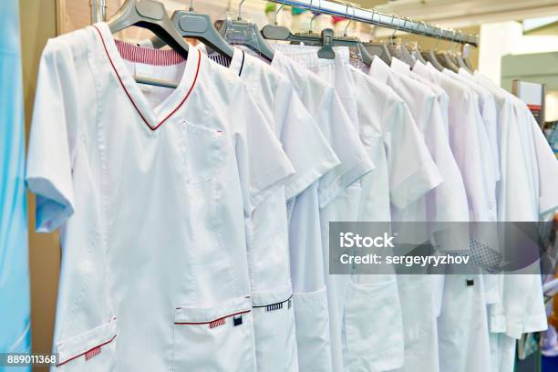 Medical Gowns For Nurses On Hanger In Store Stock Photo - Download Image Now - Uniform, Care, Coat - Garment
